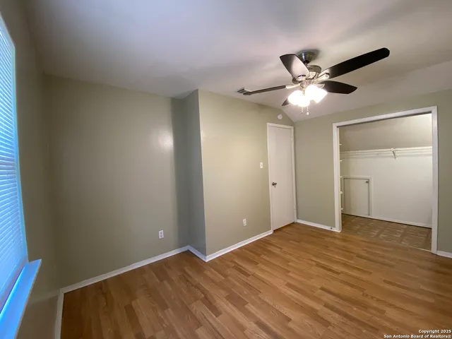 a view of empty room with wooden floor