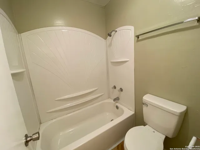 a bathroom with a toilet and a bathtub