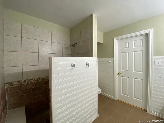 a bathroom with a shower and a sink