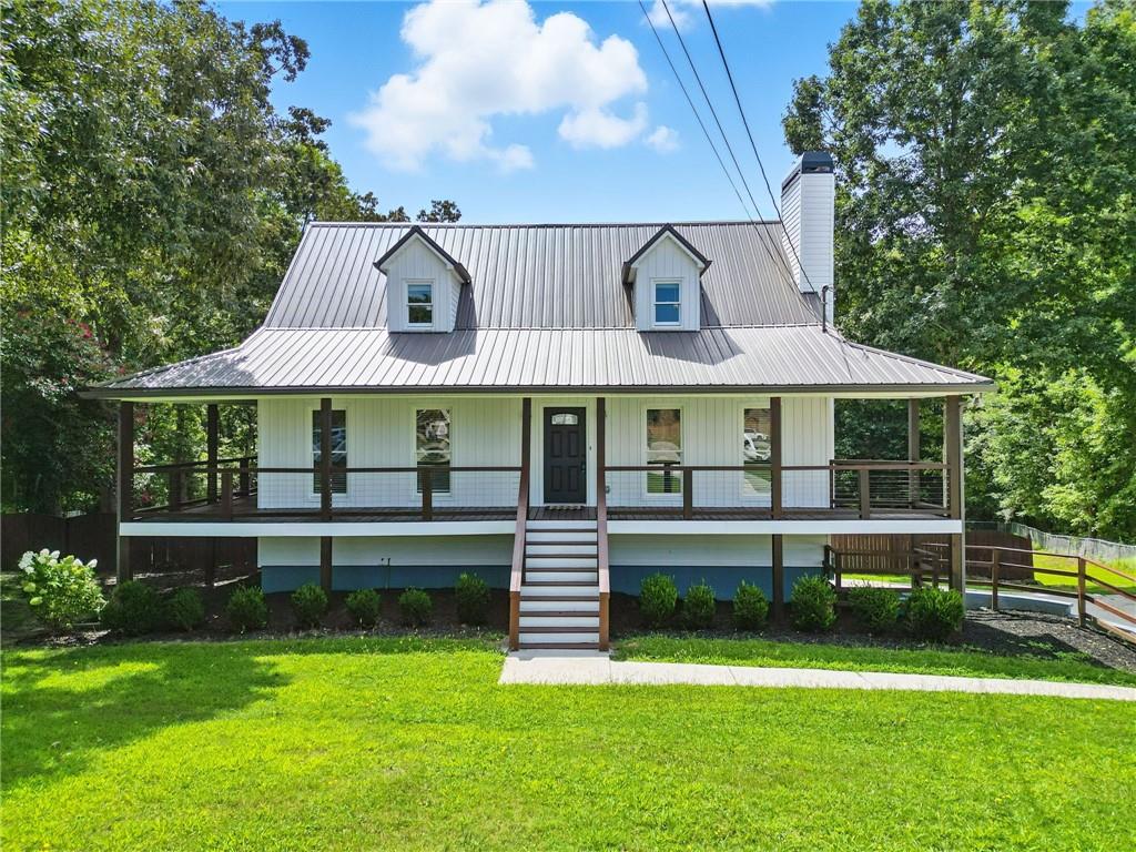 a front view of a house with a yard table and chairs