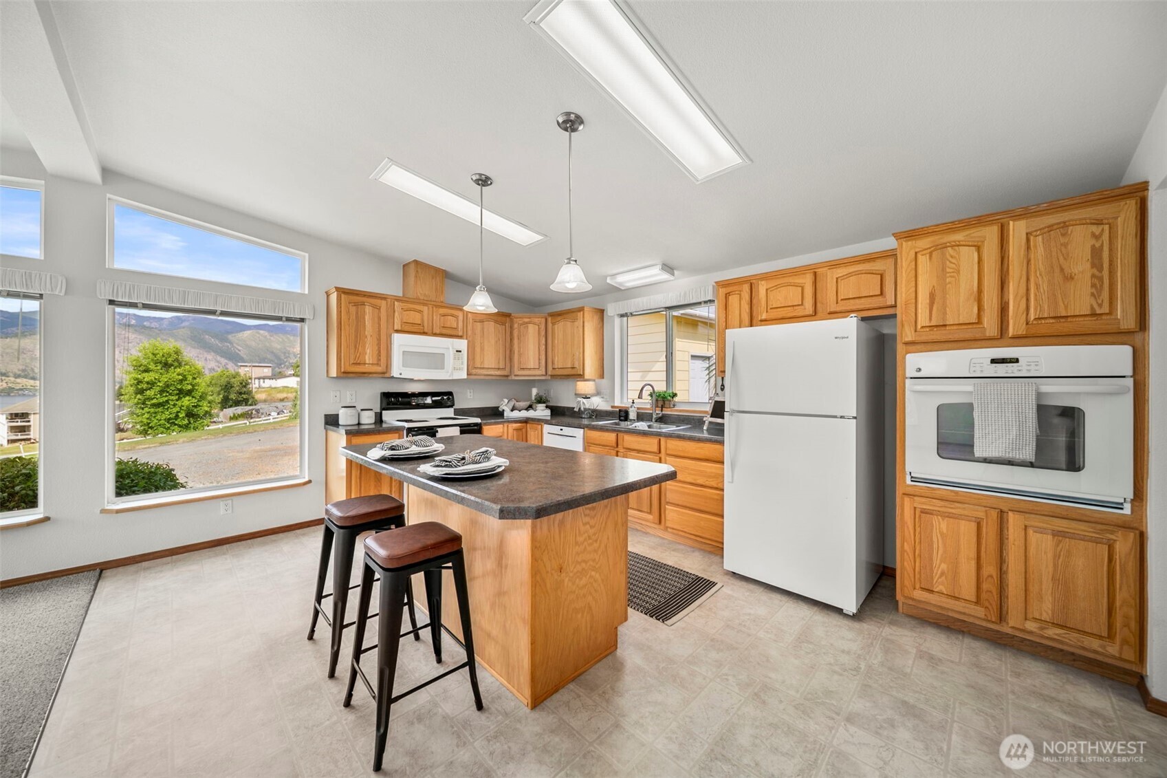 756 Totem Pole Road Manson, WA 98831 - Photo 11 of 39 a kitchen with refrigerator a sink and a large window
