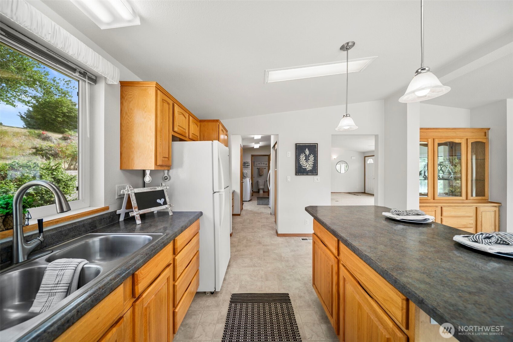 756 Totem Pole Road Manson, WA 98831 - Photo 13 of 39 a kitchen with stainless steel appliances granite countertop a sink a stove and a refrigerator
