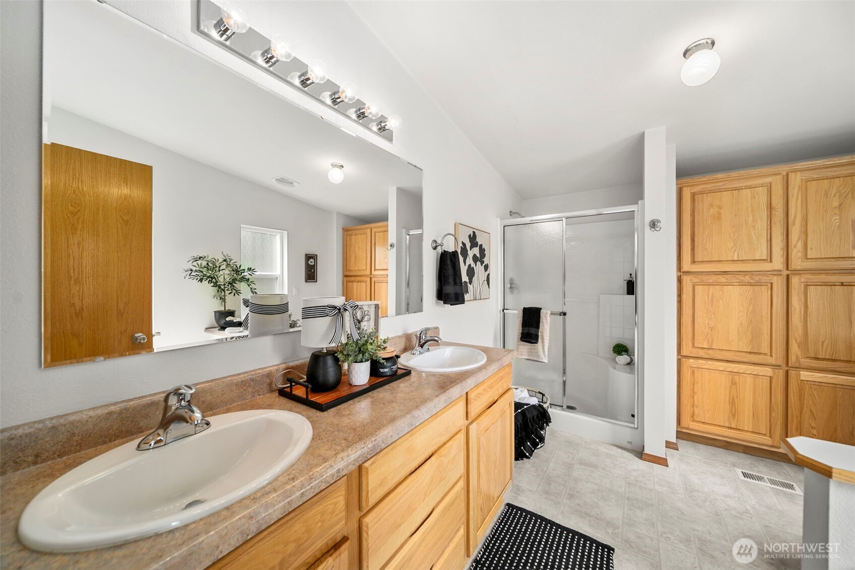 756 Totem Pole Road Manson, WA 98831 - Photo 18 of 39 a en suite bathroom with a double vanity sink a mirror and a shower