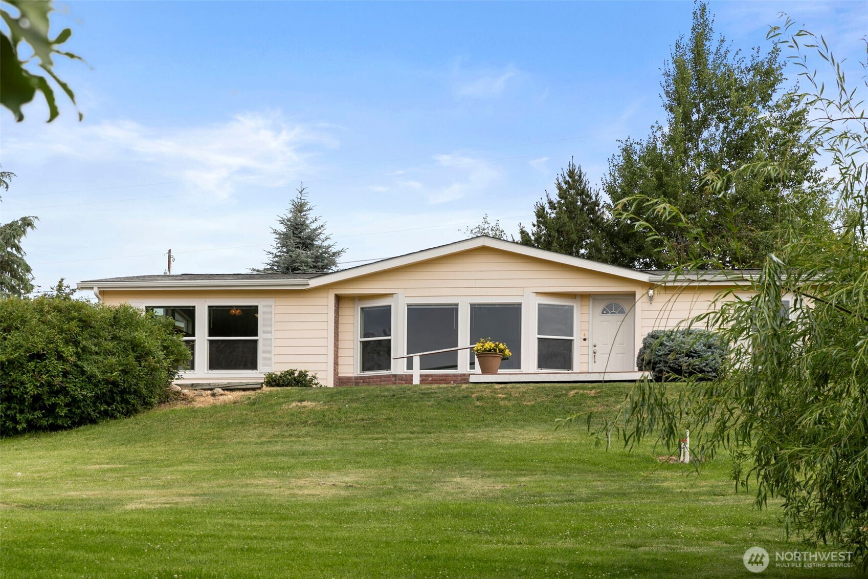 756 Totem Pole Road Manson, WA 98831 - Photo 2 of 39 a front view of a house with a garden