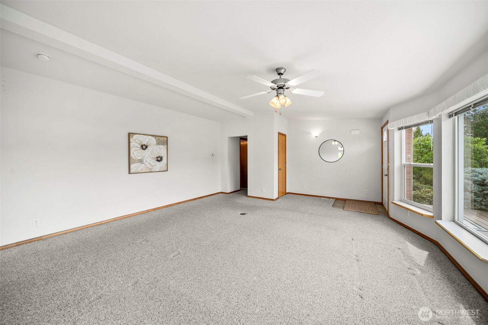 756 Totem Pole Road Manson, WA 98831 - Photo 9 of 39 an empty room with windows and chandelier fan