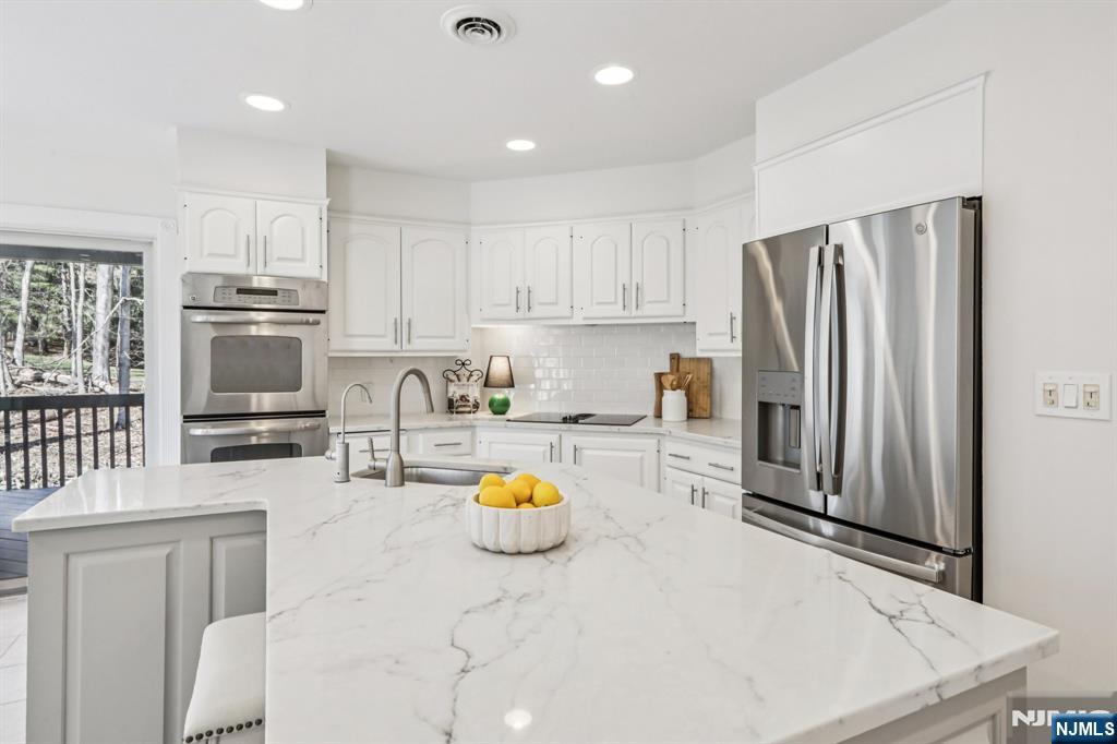 11 Carlough Road Upper Saddle River, NJ 07458 - Photo 15 of 41 a kitchen with a refrigerator and a stove top oven