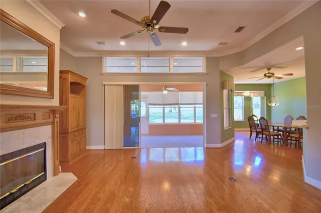 a view of a dining room with furniture wooden floor and chandelier