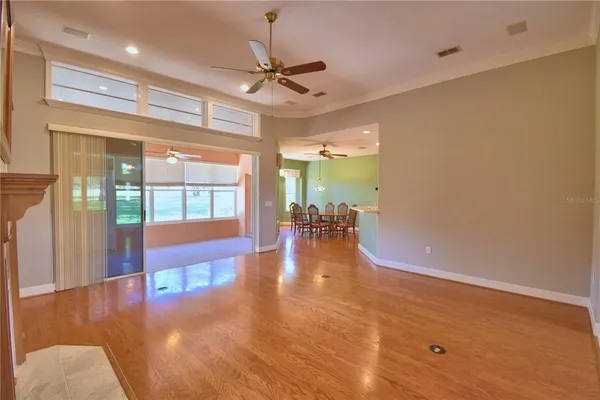 a kitchen with stainless steel appliances granite countertop a sink a stove and a wooden floors