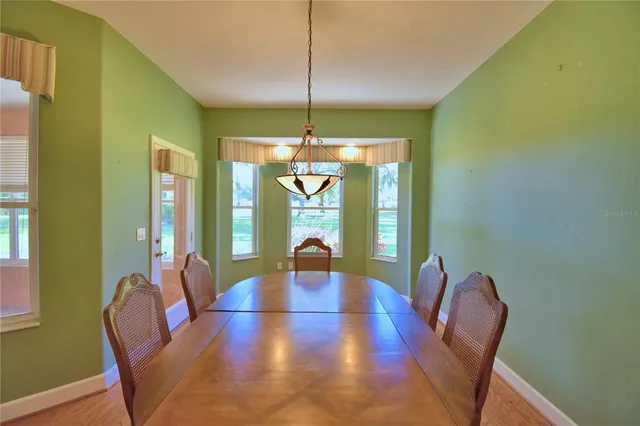a view of a hallway with wooden floor and closet