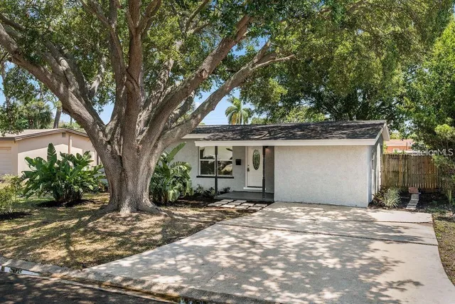 a view of a house with a tree in front