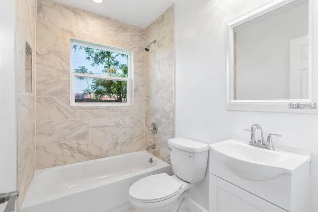 a bathroom with a sink toilet and bathtub