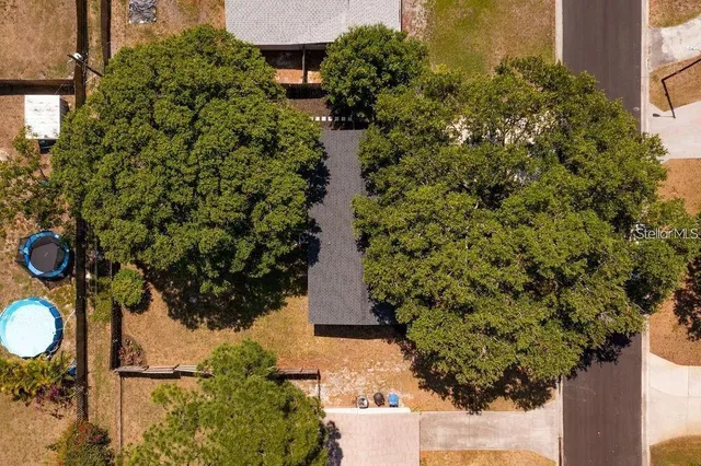 an aerial view of a house with a yard