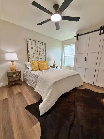 a bedroom with a bed and a ceiling fan
