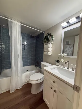 a bathroom with a sink toilet a mirror and shower