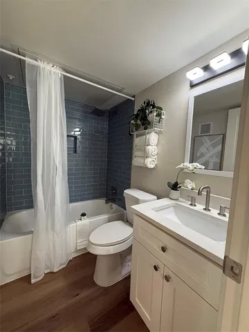 a bathroom with a sink toilet a mirror and shower