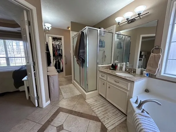 a bathroom with a double vanity sink a mirror and shower