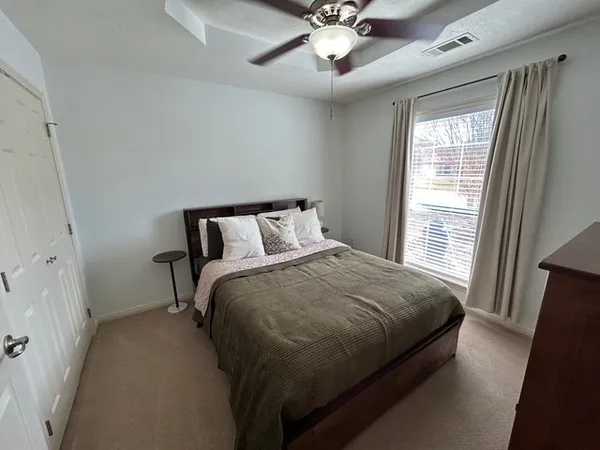 a bedroom with a bed and window