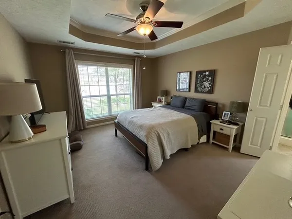 a bedroom with a bed and a couch