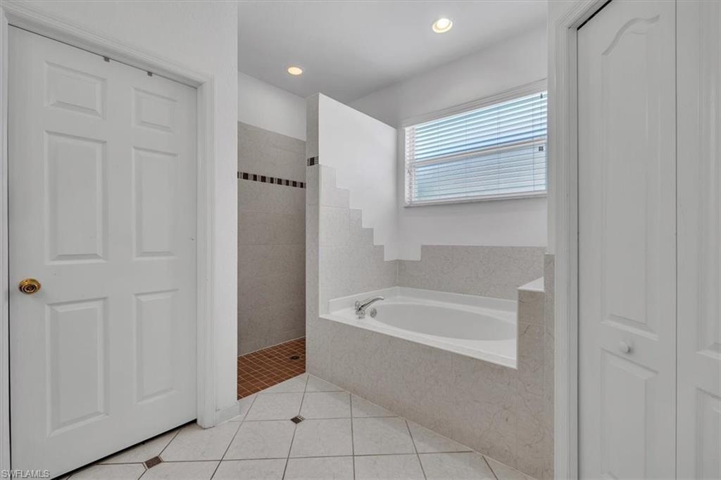12914 Stone Tower Loop Fort Myers, FL 33913 - Photo 21 of 50 a spacious bathroom with a bathtub and a shower