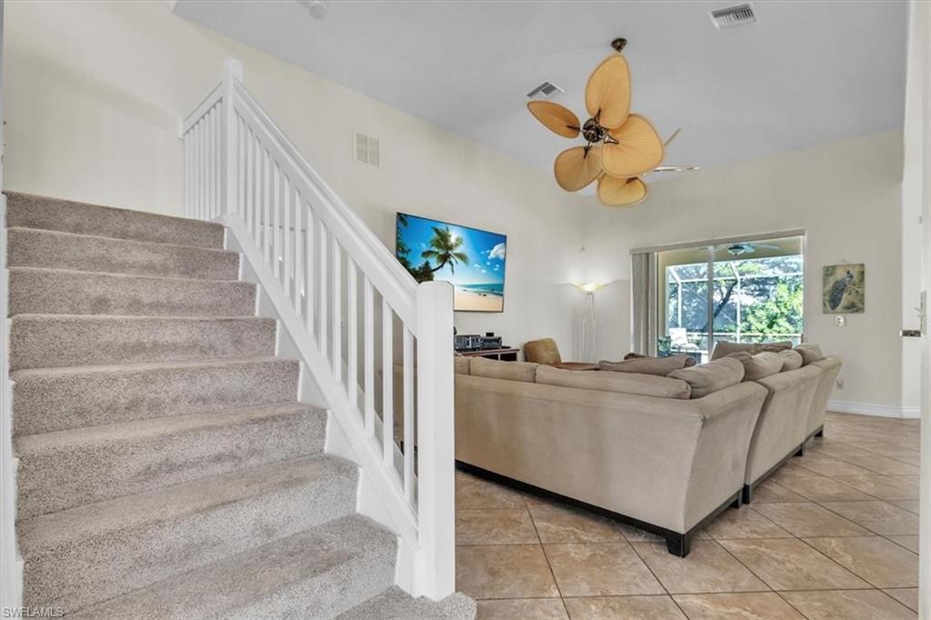 12914 Stone Tower Loop Fort Myers, FL 33913 - Photo 22 of 50 a living room with couches chandelier cabinets and a window