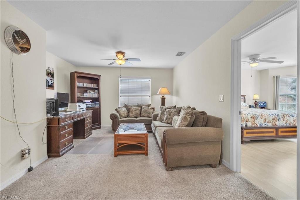 12914 Stone Tower Loop Fort Myers, FL 33913 - Photo 24 of 50 a living room with furniture and a flat screen tv