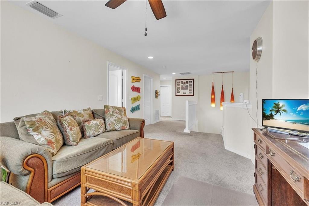 12914 Stone Tower Loop Fort Myers, FL 33913 - Photo 25 of 50 a living room with furniture and a flat screen tv