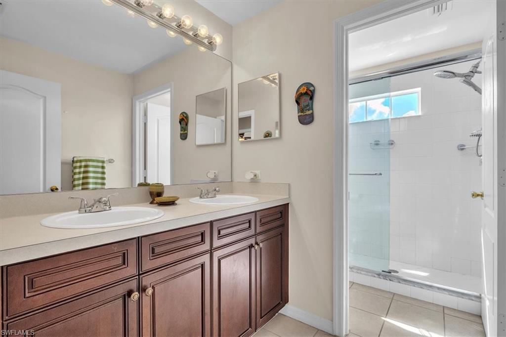 12914 Stone Tower Loop Fort Myers, FL 33913 - Photo 30 of 50 a bathroom with a granite countertop sink and a mirror