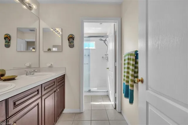 a spacious bathroom with a granite countertop sink and a mirror
