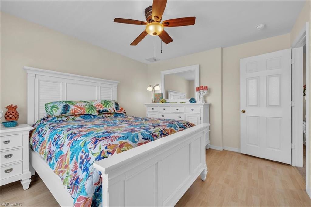 12914 Stone Tower Loop Fort Myers, FL 33913 - Photo 32 of 50 a bed room with a bed a chandelier and a dresser