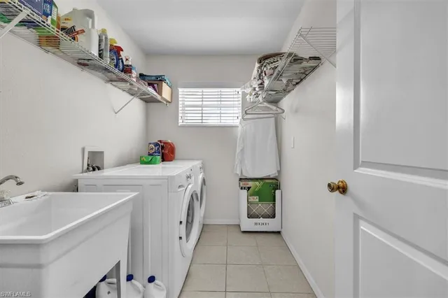 a utility room with cabinets washer and dryer