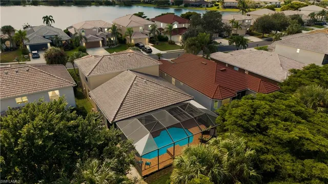 an aerial view of a house with outdoor space and lake view
