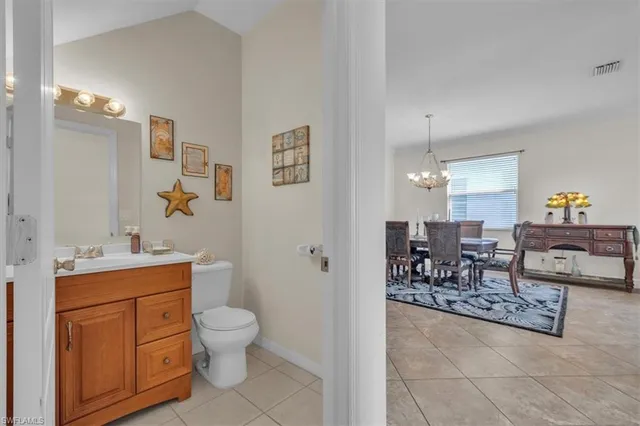 a spacious bathroom with a toilet a sink and a mirror