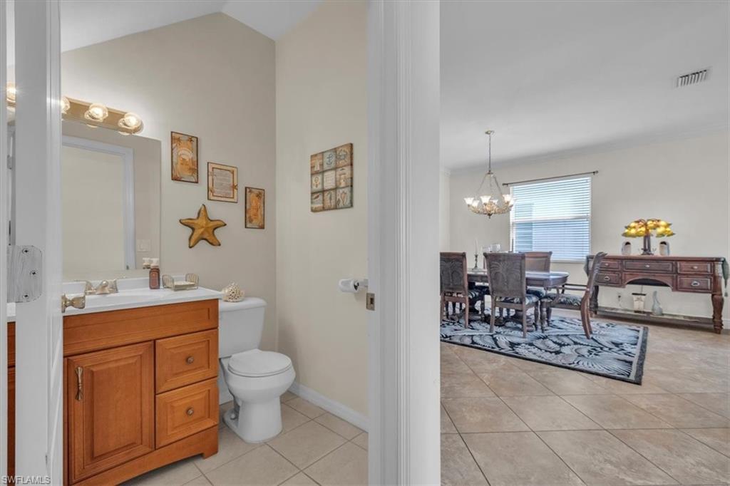 12914 Stone Tower Loop Fort Myers, FL 33913 - Photo 7 of 50 a spacious bathroom with a toilet a sink and a mirror