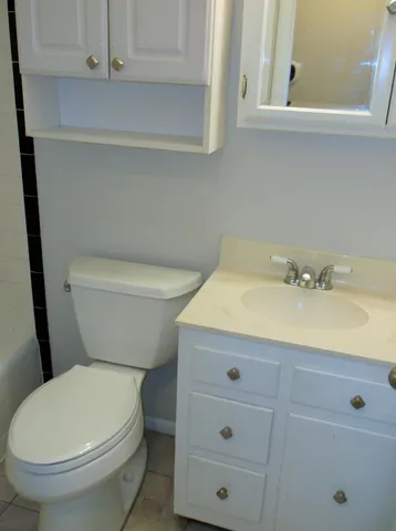 a bathroom with a shower a toilet and a sink