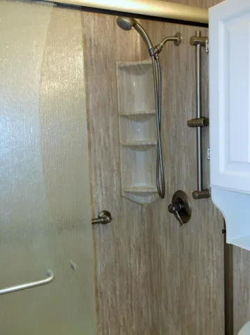 a white toilet sitting next to a shower