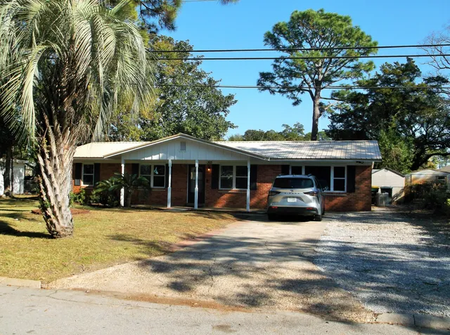 a view of a house with backyard porch and sitting area