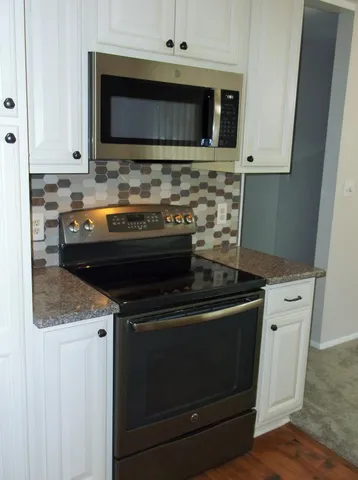 a stove top oven sitting inside of a kitchen