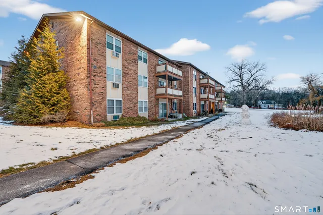 a view of a house with a snow in the yard