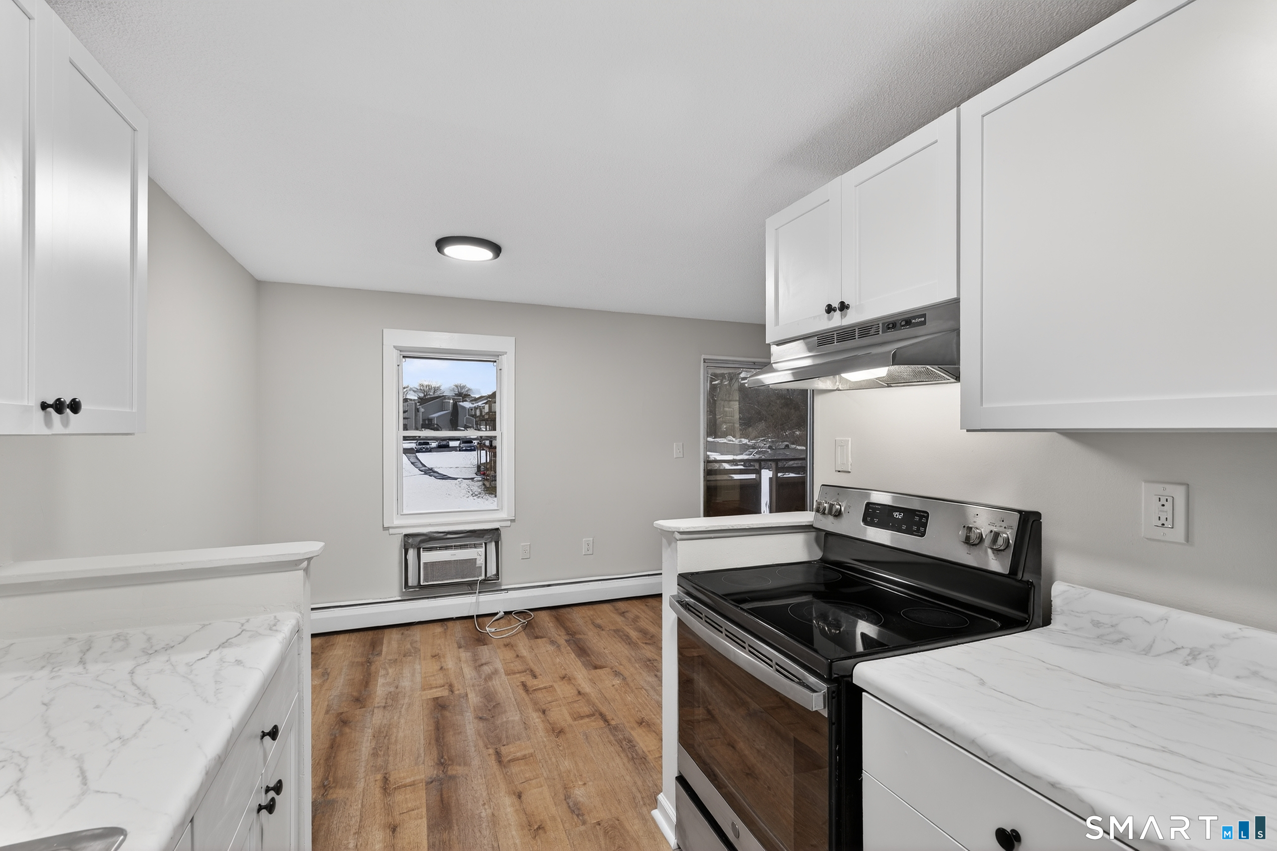45 Jefferson Road, Unit 37 Branford, CT 06405 - Photo 12 of 24 a kitchen with granite countertop a stove and a sink