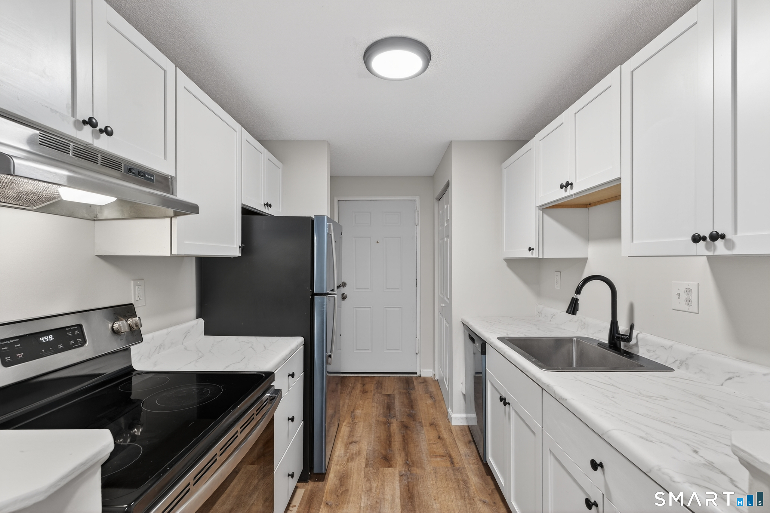45 Jefferson Road, Unit 37 Branford, CT 06405 - Photo 15 of 24 a kitchen with a sink stove and cabinets