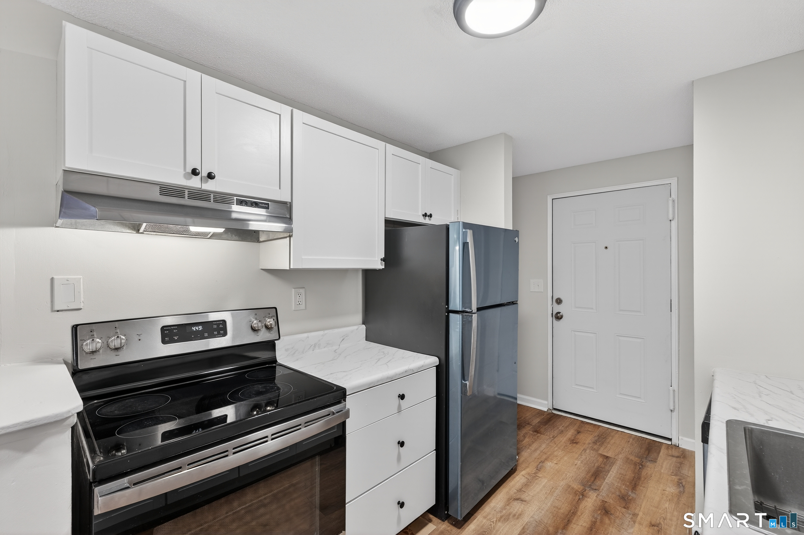 45 Jefferson Road, Unit 37 Branford, CT 06405 - Photo 16 of 24 a kitchen with a refrigerator and a stove top oven