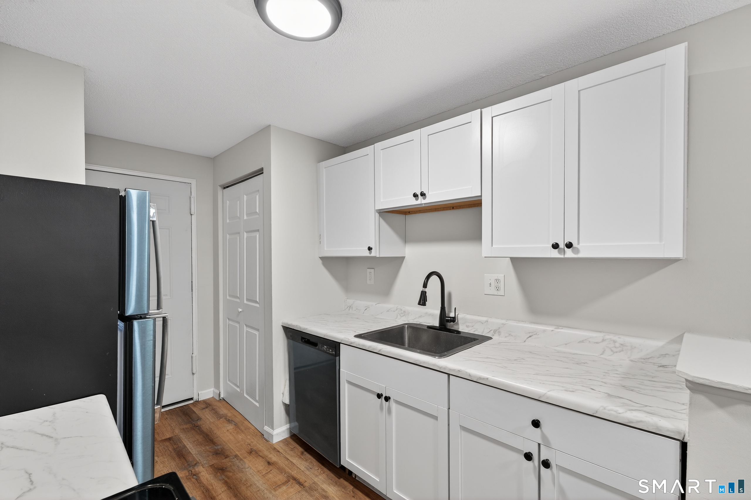 45 Jefferson Road, Unit 37 Branford, CT 06405 - Photo 17 of 24 a kitchen with a sink cabinets and refrigerator