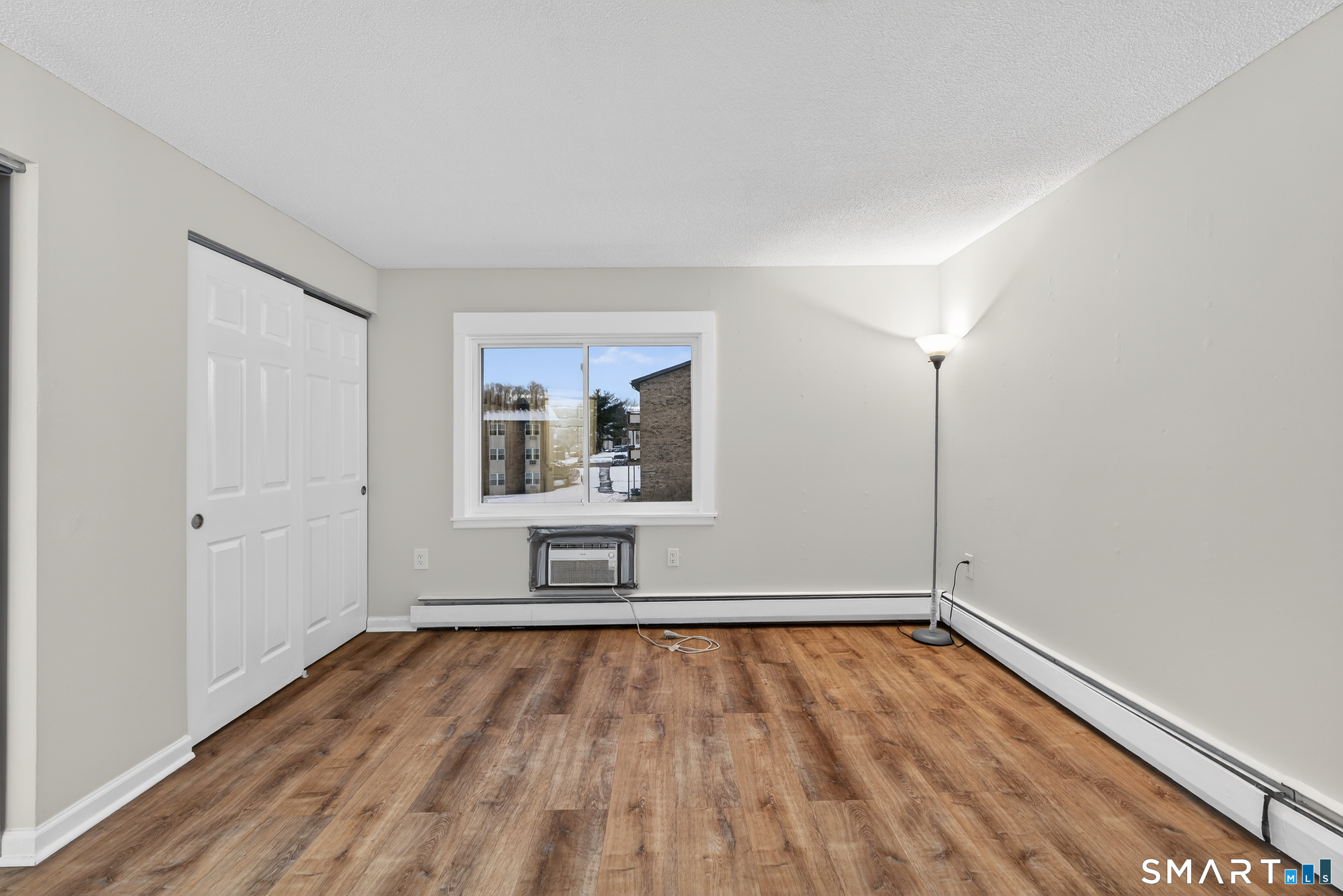 45 Jefferson Road, Unit 37 Branford, CT 06405 - Photo 18 of 24 an empty room with wooden floor and windows