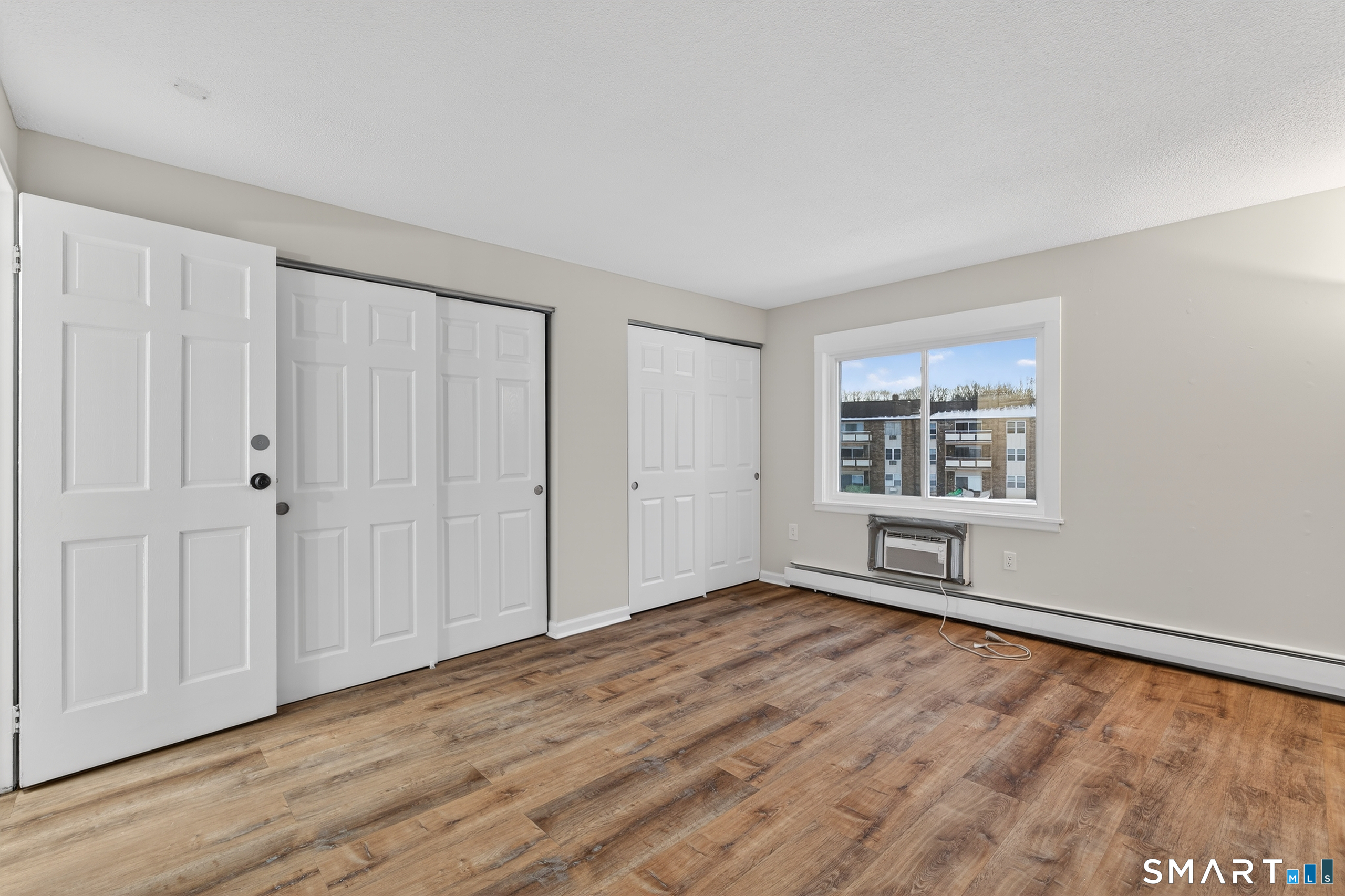 45 Jefferson Road, Unit 37 Branford, CT 06405 - Photo 20 of 24 a view of an empty room with wooden floor and a window