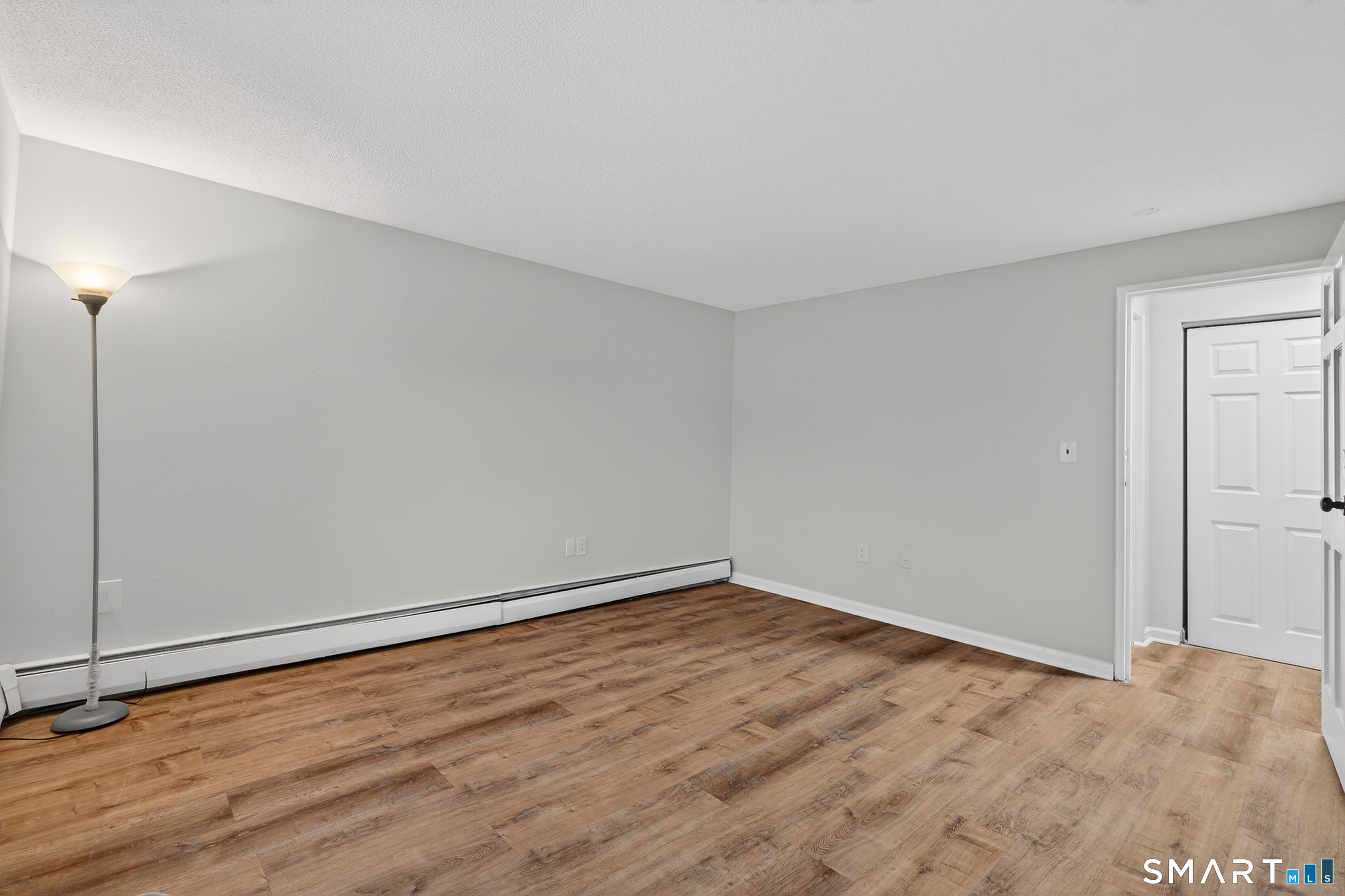 45 Jefferson Road, Unit 37 Branford, CT 06405 - Photo 21 of 24 a view of an empty room with wooden floor