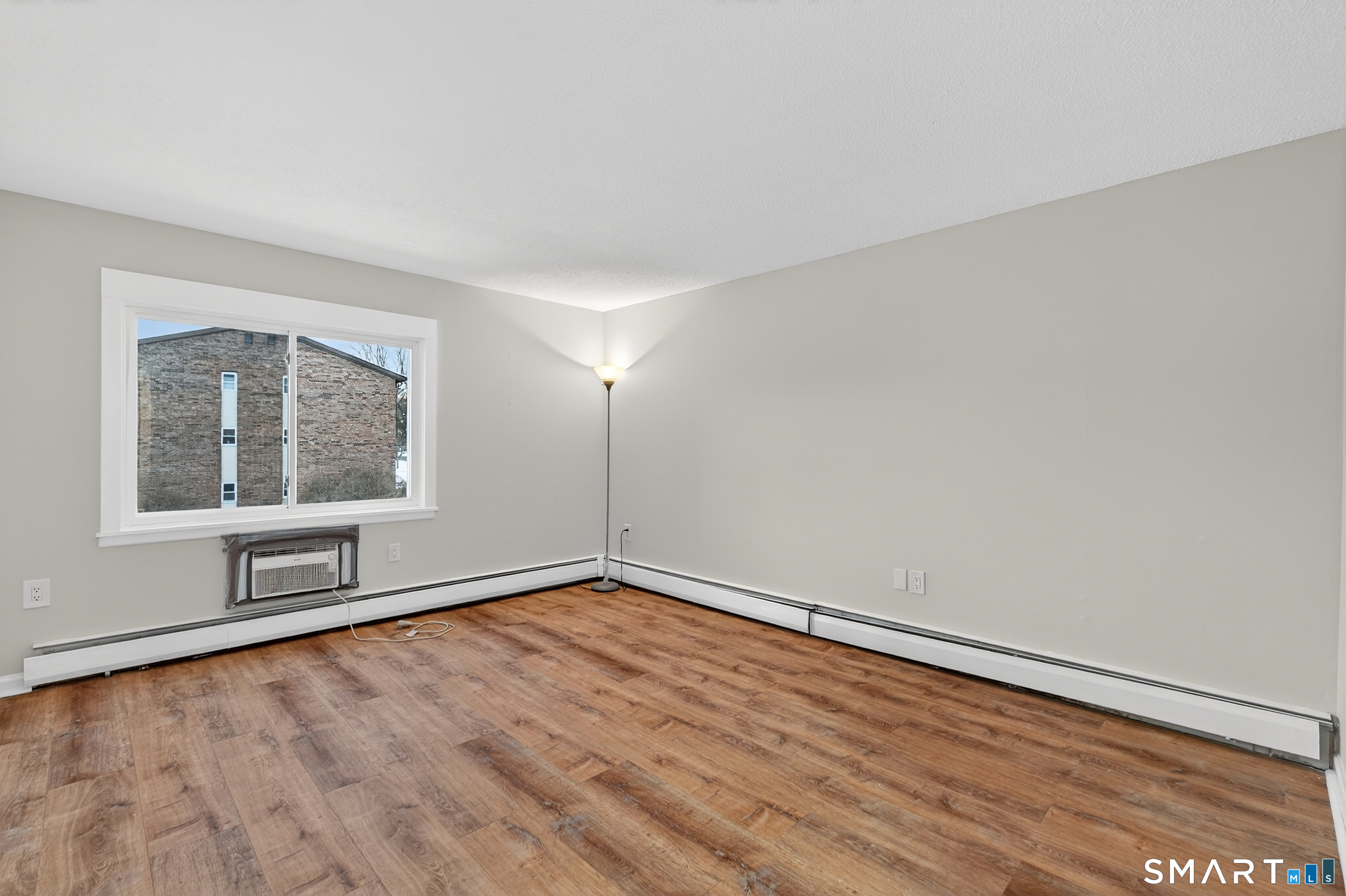 45 Jefferson Road, Unit 37 Branford, CT 06405 - Photo 22 of 24 an empty room with wooden floor and windows