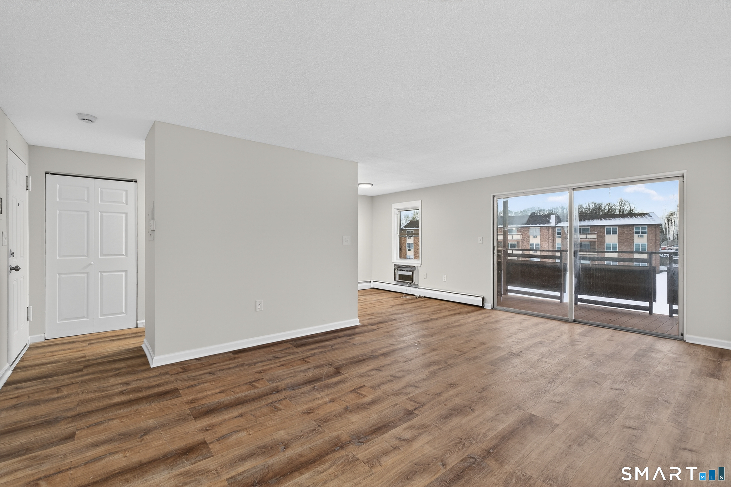 45 Jefferson Road, Unit 37 Branford, CT 06405 - Photo 7 of 24 a view of an empty room with wooden floor and fireplace