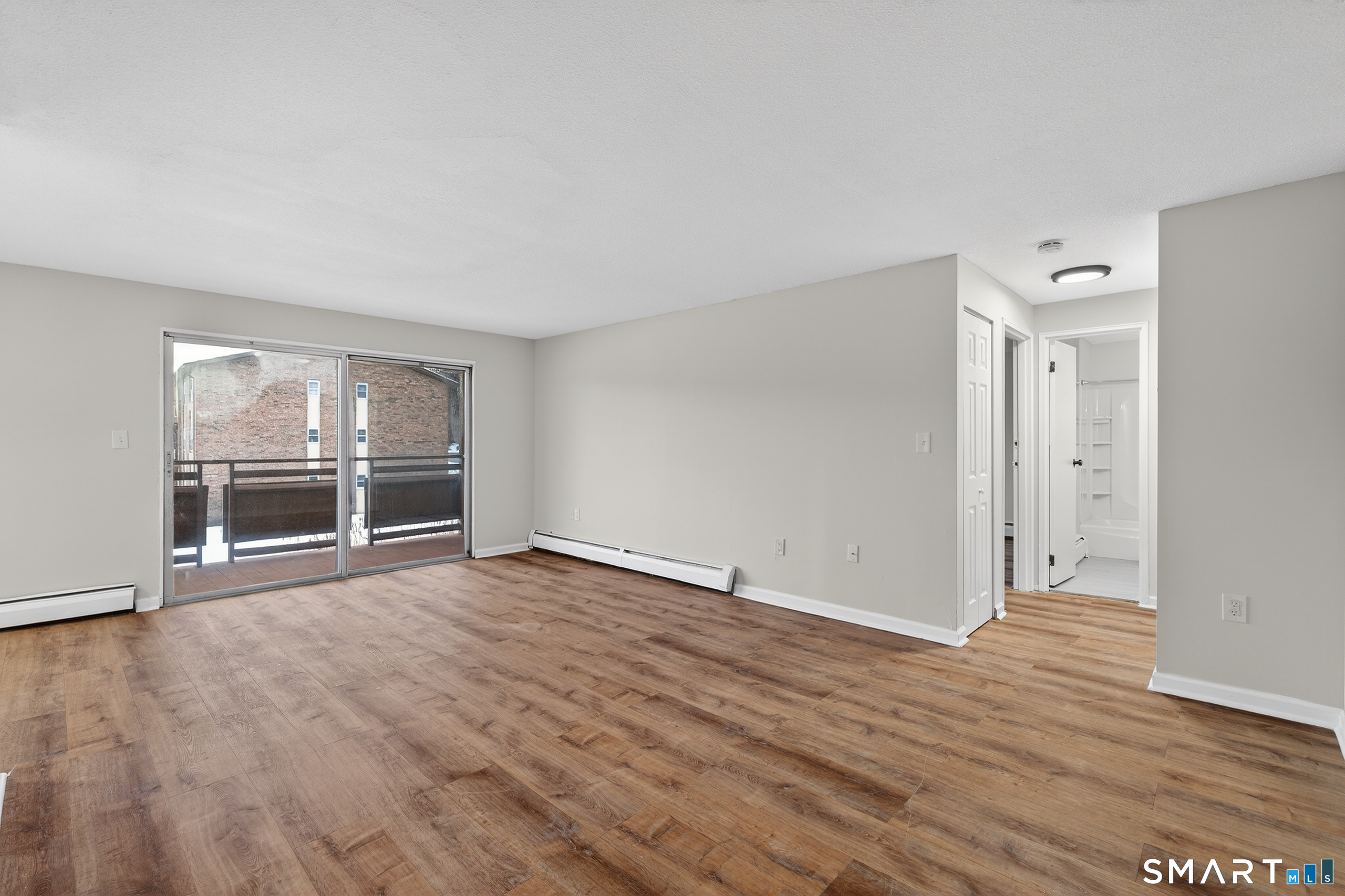 45 Jefferson Road, Unit 37 Branford, CT 06405 - Photo 8 of 24 an empty room with wooden floor and windows