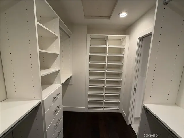 an empty room with wooden floor and closet