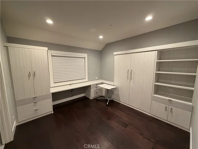 an empty room with wooden floor and closet
